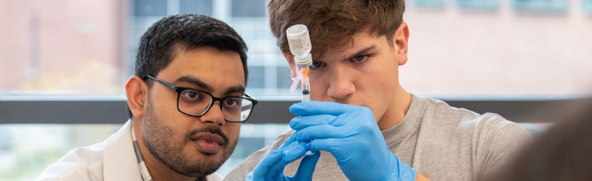 Pharmacy student prepares to give immunization.