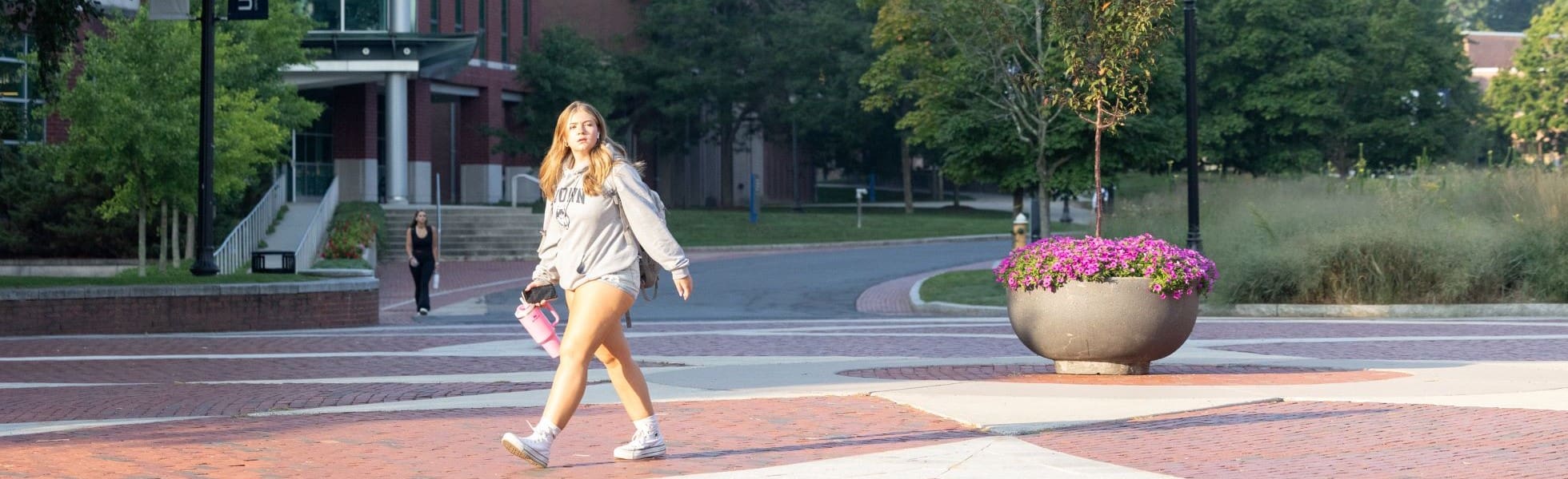 UConn student walking across campus.